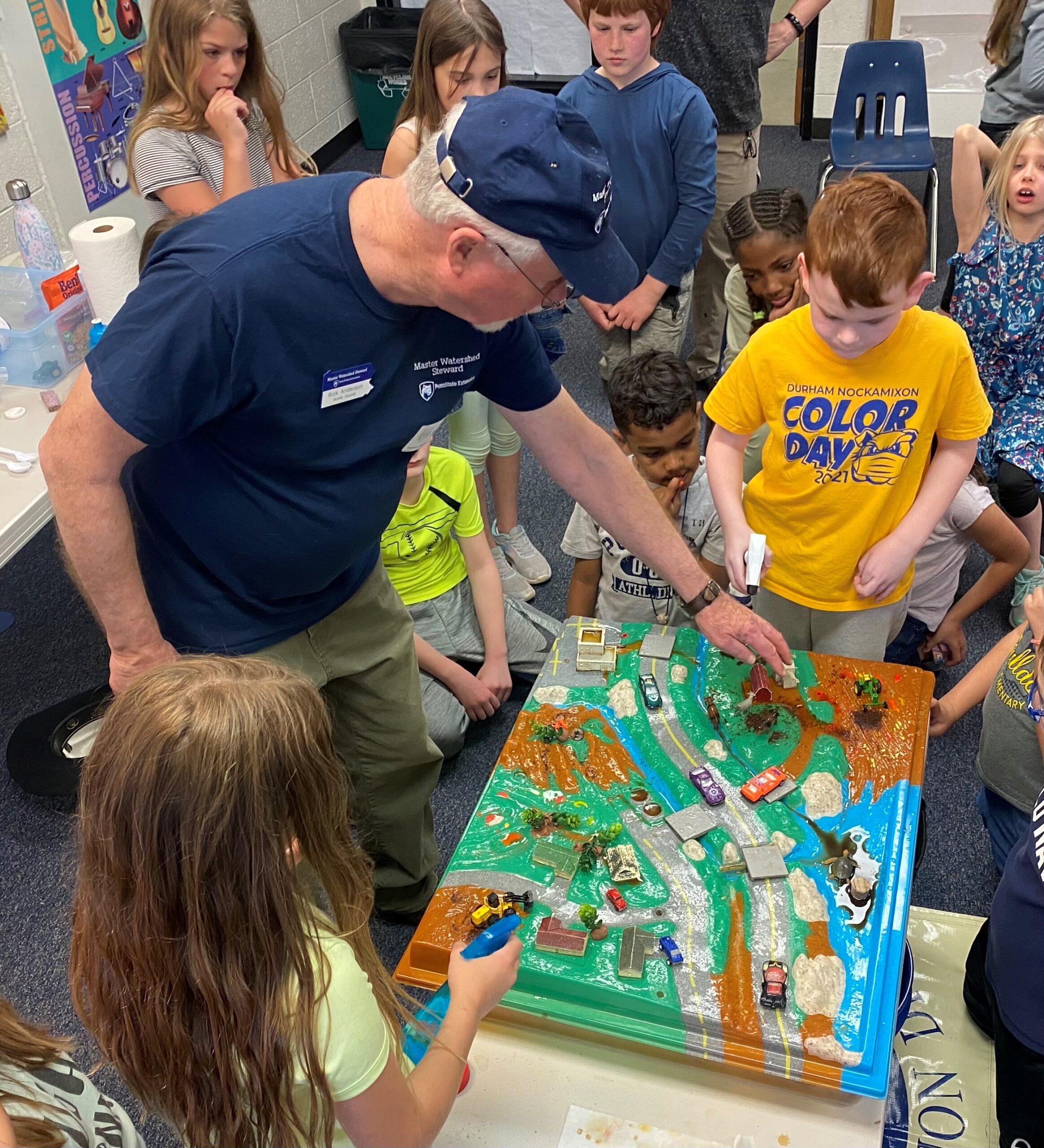 A demonstration of the plastic Enviroscape model for a group of kids.
